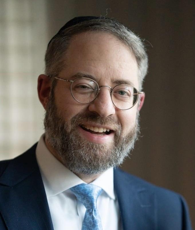 Maurice A. Deutsch, President of HBFG, smiling in a suit and glasses, representing leadership in the biohazard cleanup industry.